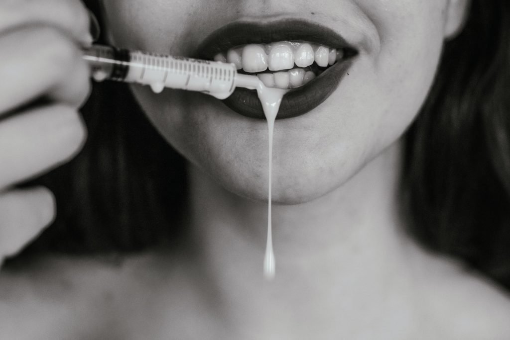 woman with white plastic medical tool on her mouth